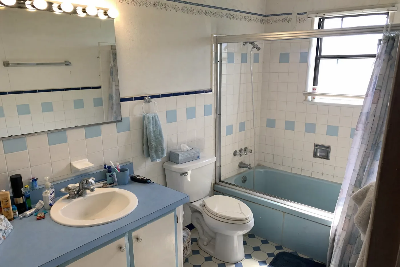 Dated blue bathroom before remodel