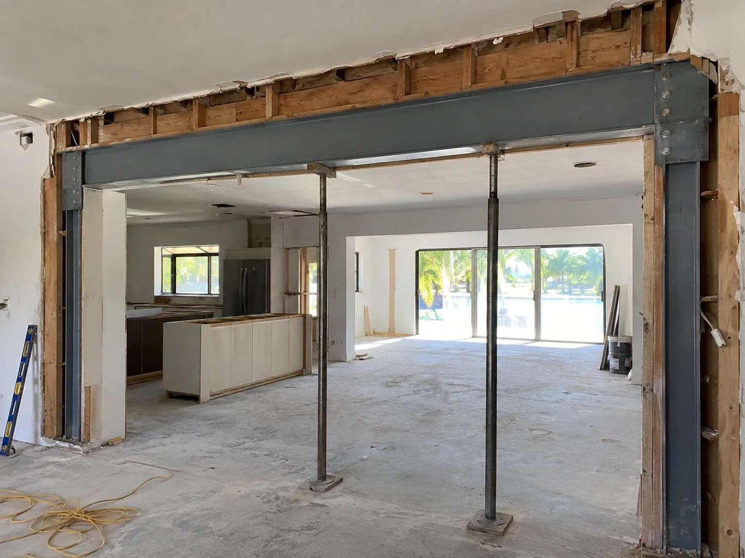 Load-bearing wall replaced with a steel beam on steel posts in a Miami home